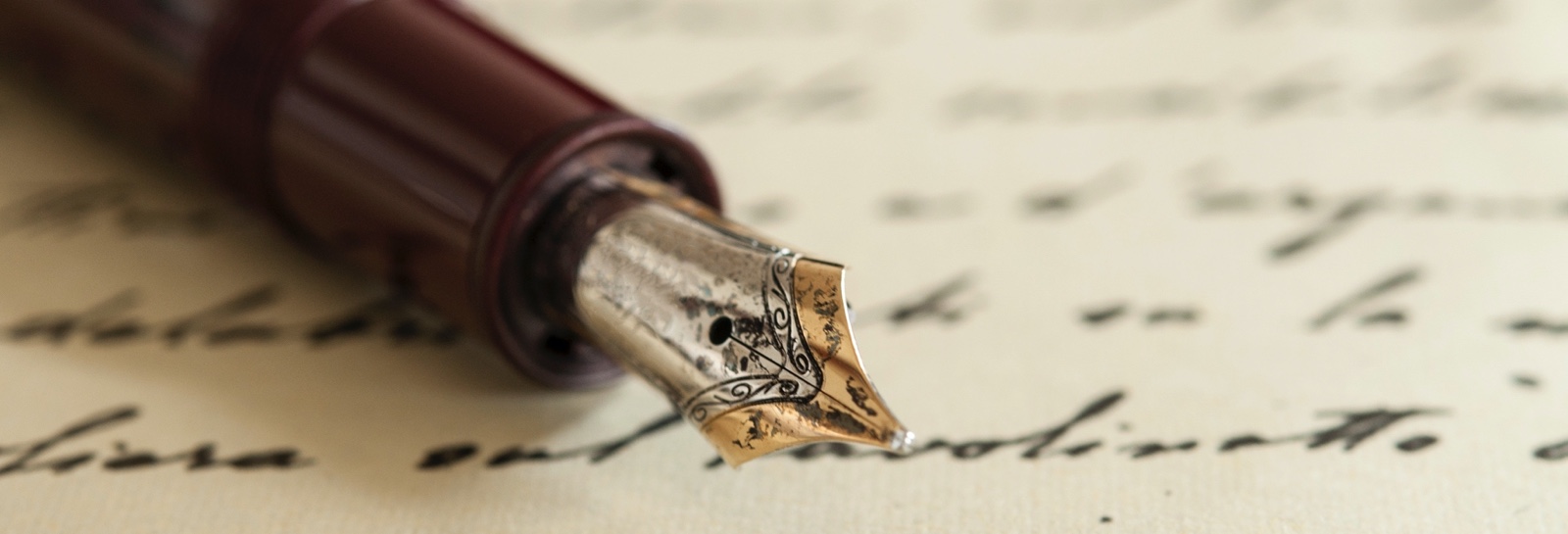 an inkwell pen sitting on a letter