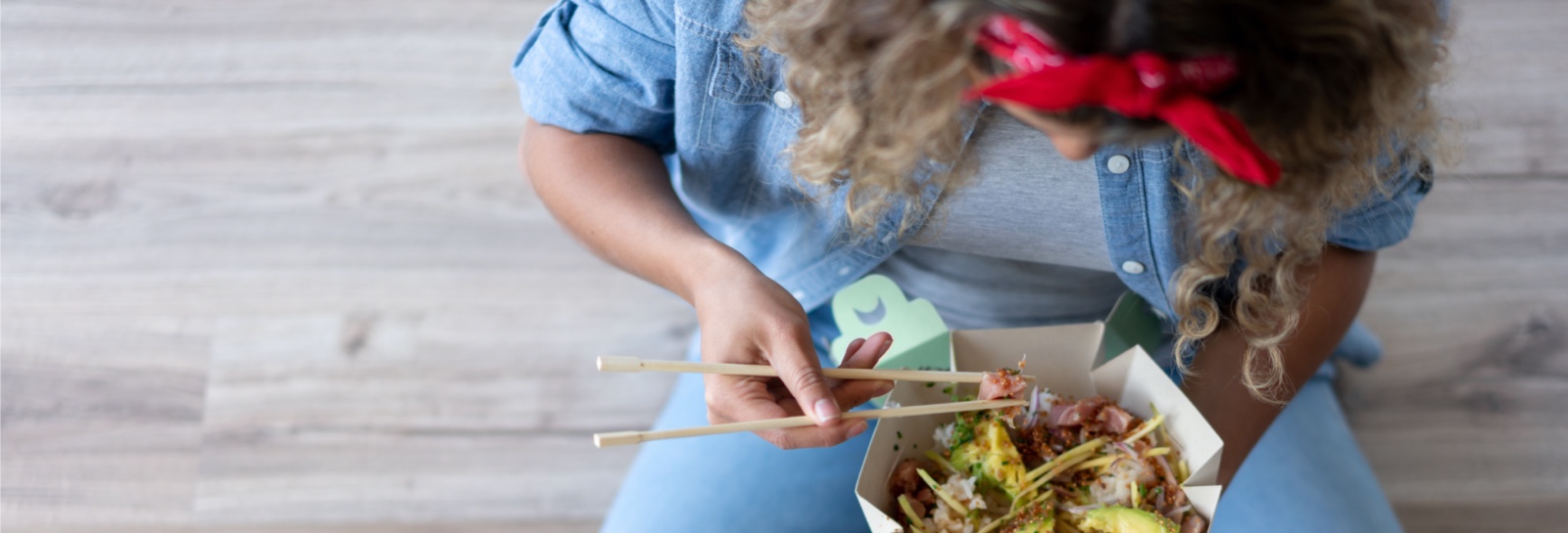 a top down shot of someone eating chinese food with chopsticks